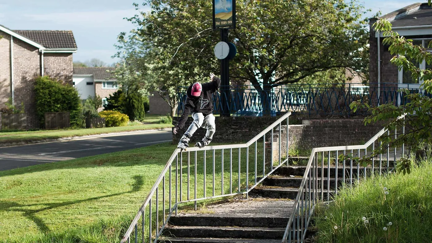 A skater in ENIGMA MADE clothing on a handrail